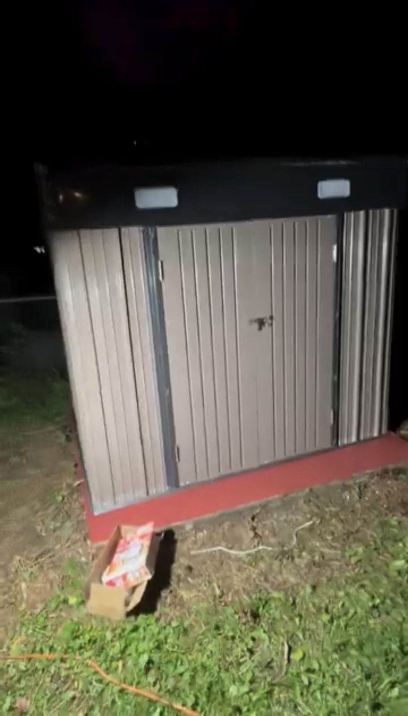 The completed metal storage shed with the doors closed.