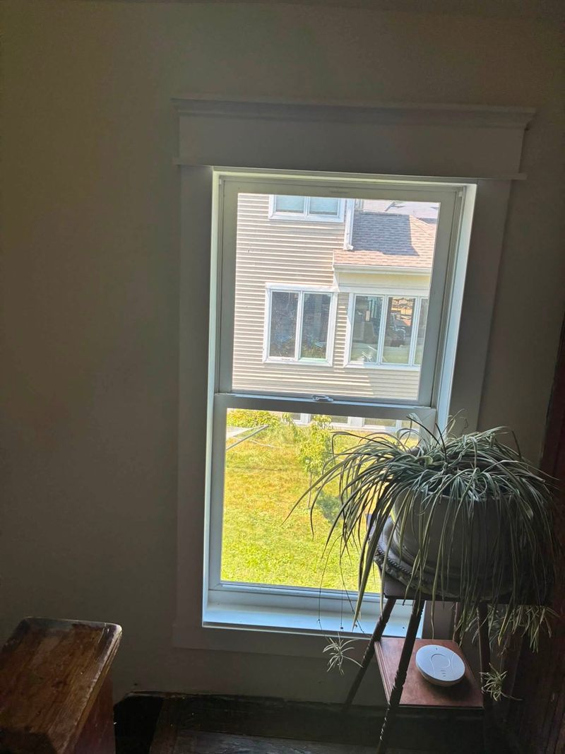 Finished window trim with a built-up decorative header.